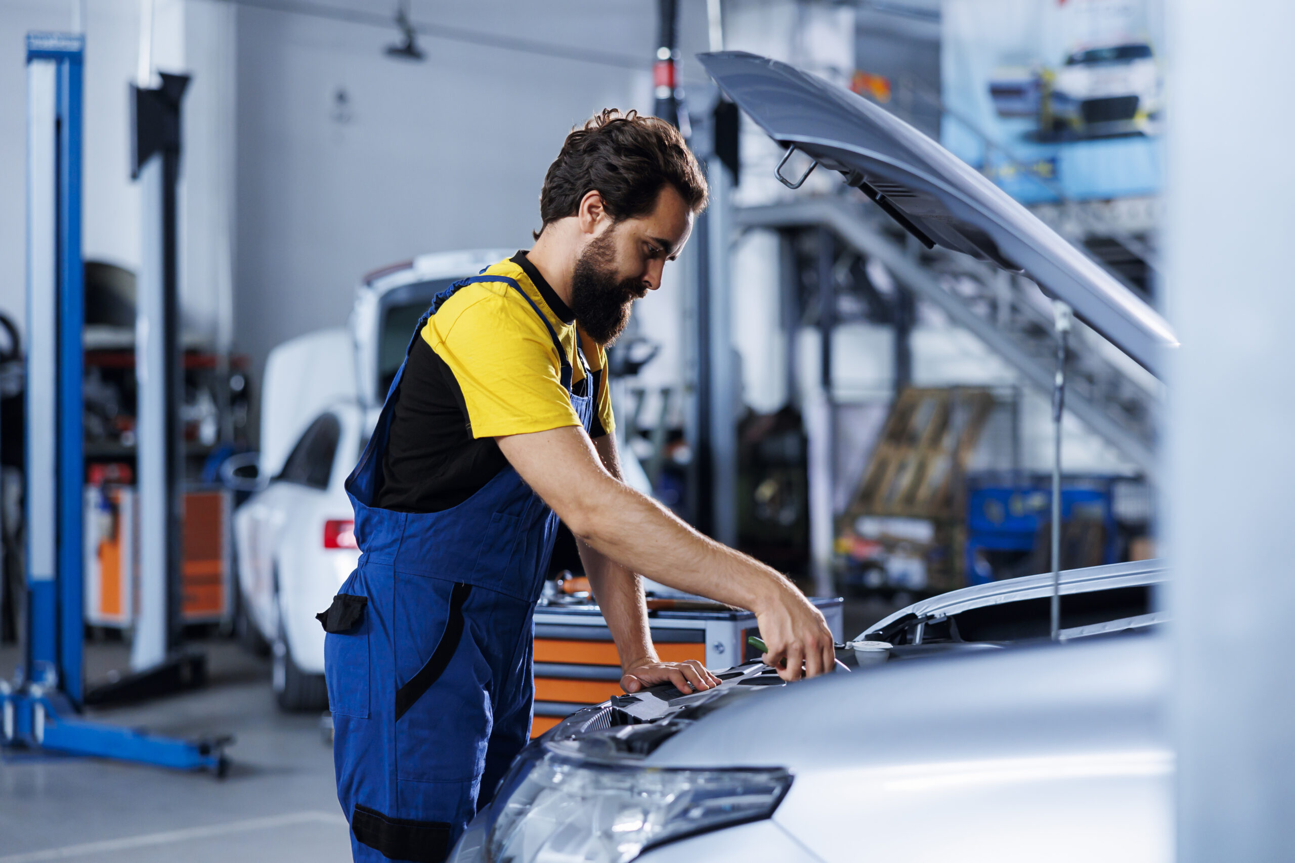 Specialist replaces car engine in garage