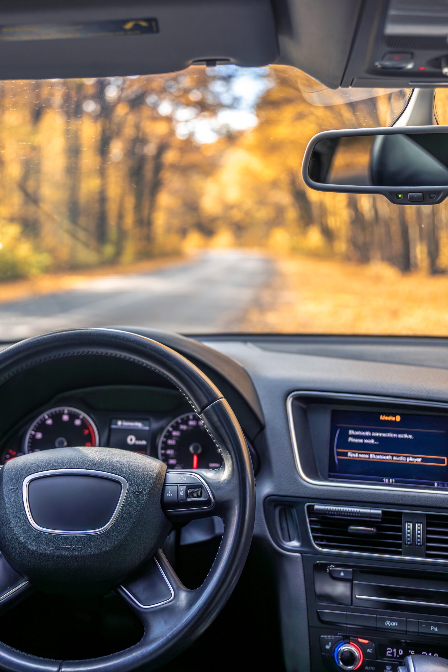 Car view from the inside. Car steering wheel and interior.